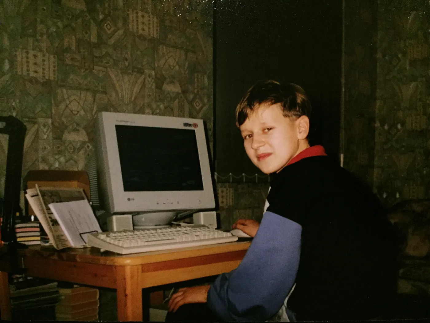 Young Sergei Golubev sitting at a desktop PC with a CRT monitor in Estonia, circa 1999